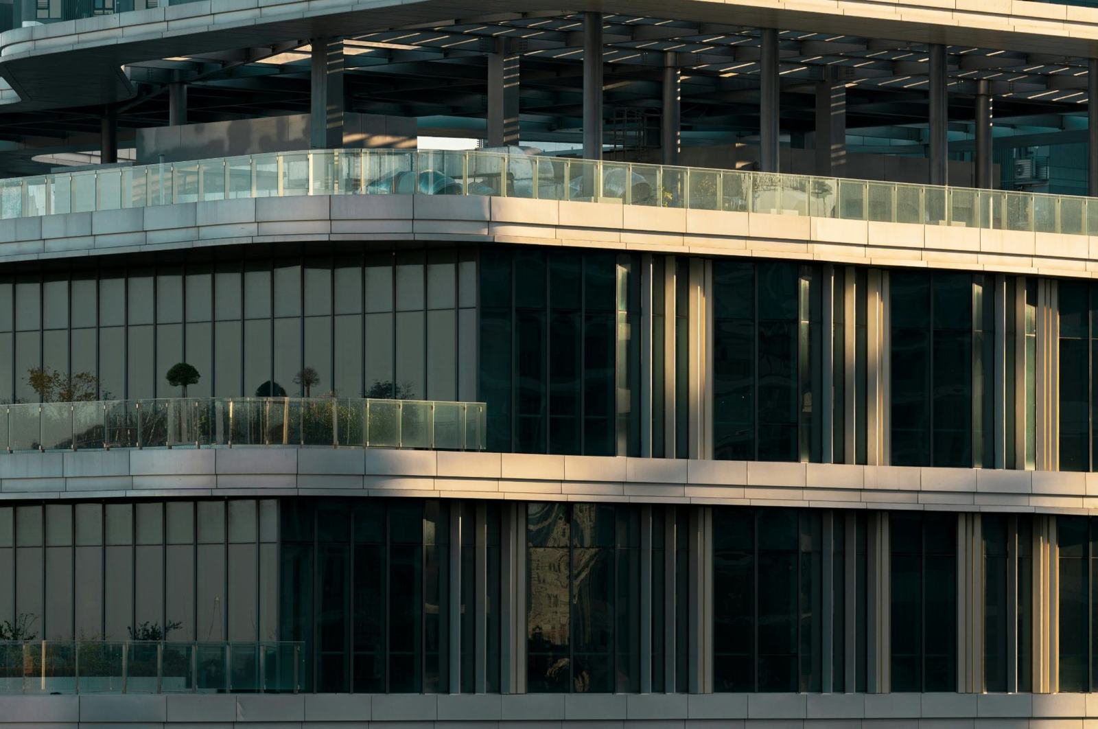Terraced contemporary building with glass facades in late-afternoon light